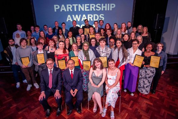 Staff and students gather for photo at University Partnership awards ceremony