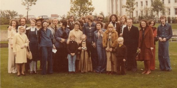 A 1970s photograph showing a large gamily group stood in a line facing the camera