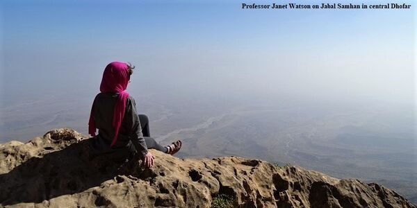 Professor Janet Watson sits on a hillside overlooking Dhofar
