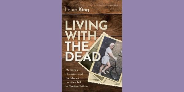 The cover of Laura King living with the dead. A photograph of a women in the 1920s wearing a beret and holding a bicycle, against an image of a wooden background.