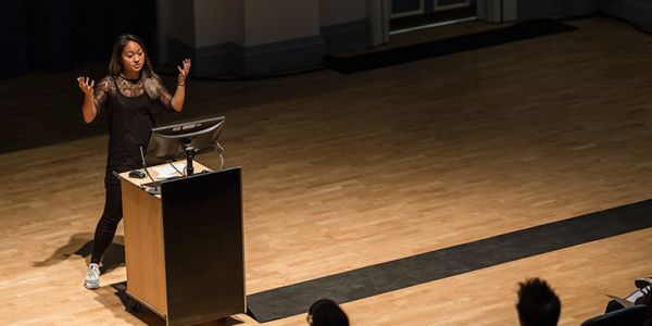 Person delivering a talk in a lecture theatre