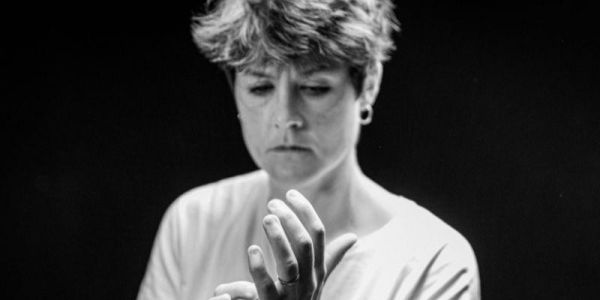 Kate Ledger vocal and instrumental teacher in the School of Music. Kate looks down at her hands and the image is taken in black and white.