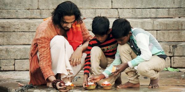 Father and sons lighting candles