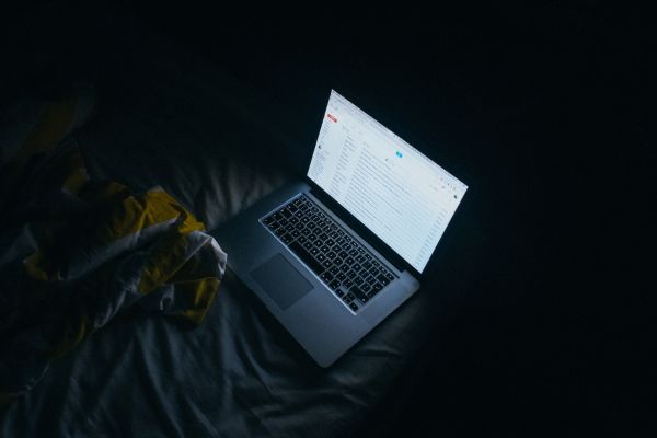 A laptop glowing in the dark