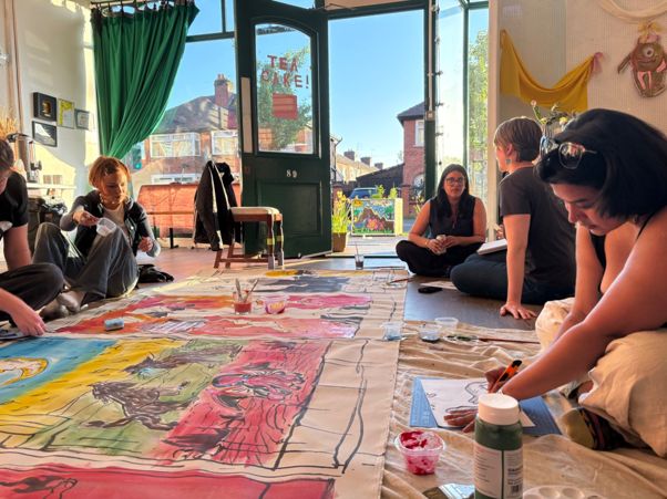 People sit and create artworks