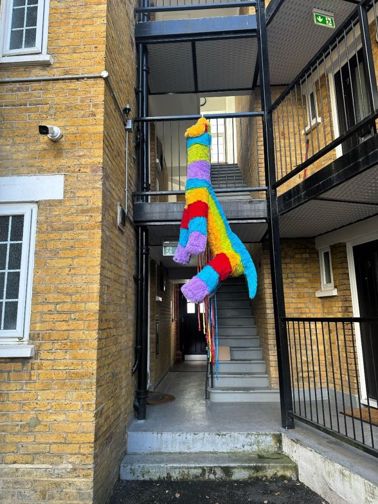 Pinata of an inflatable llama sculpture displayed at a residential block.