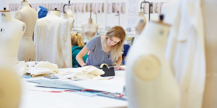 Student in a studio with manikins