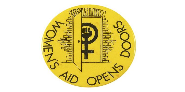 Image of Women's Aid Opens Doors logo. Circular yellow background with contrasting clenched fist merged with Venus symbol entering doorway.