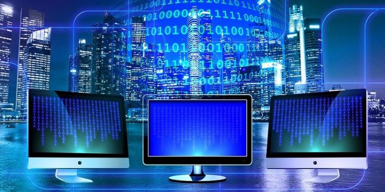 Three monitors against a blue tech-symbol backdrop