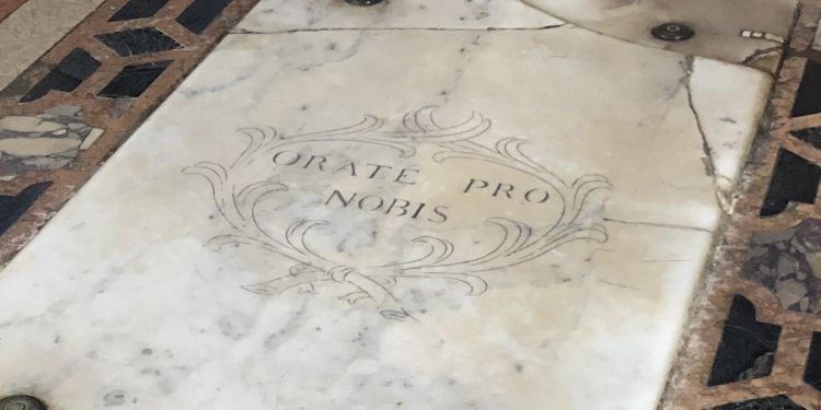 A marble tombstone with the Latin inscription orate pro nobis.