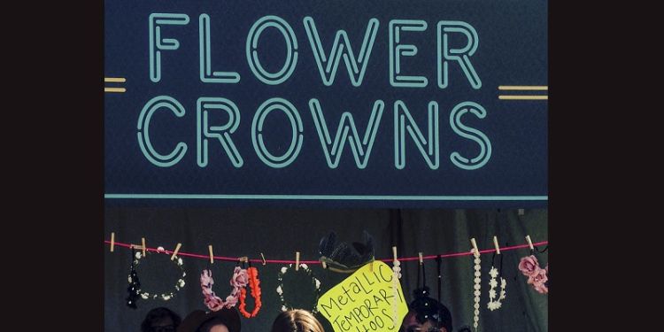 A sign saying Flower crowns above a temporary tattoo sign