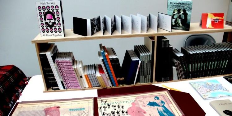 A selection of artists’ books from the Wild Pansy Press on a table and shelves