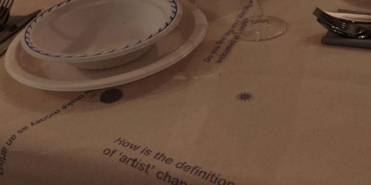 Installation by Nocturne of a table setting and screen printed statements about art and artists.