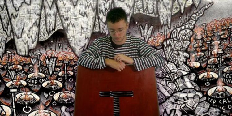 Film still from John Ledger's 'Wall, i' showing the lead character (played by Ben Crawford, in front of a painted wall.