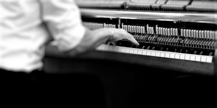 Male figure playing piano - black and white