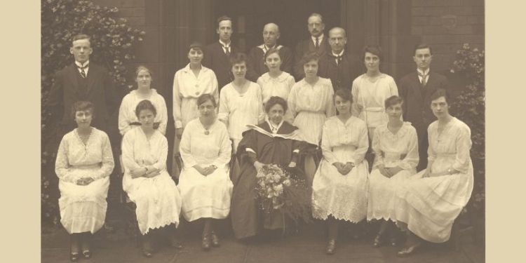 A group of Edwardian women and men, sitting for a formal photograph