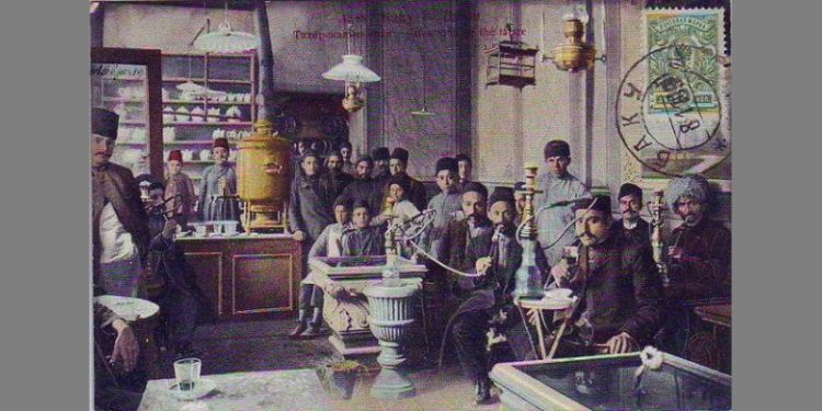 Old-style image of men sitting in public coffee shop with pipes