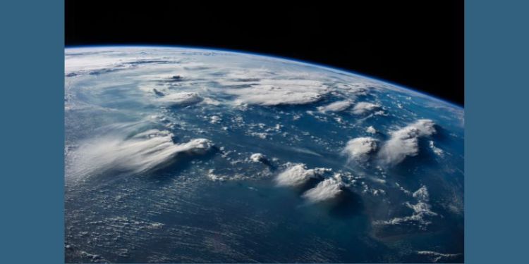 Thunderheads near Borneo, Indonesia, in an imag taken from space. The earth appears blue with different cloud formations visible in the atmosphere.