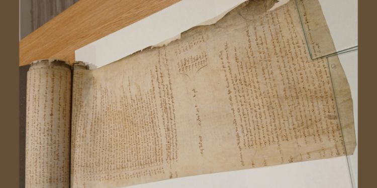 A medieval parchment scroll covered with small handwriting.