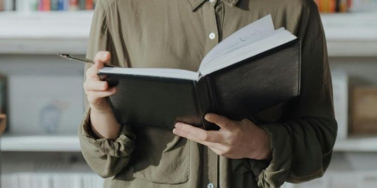 Person holding a book.