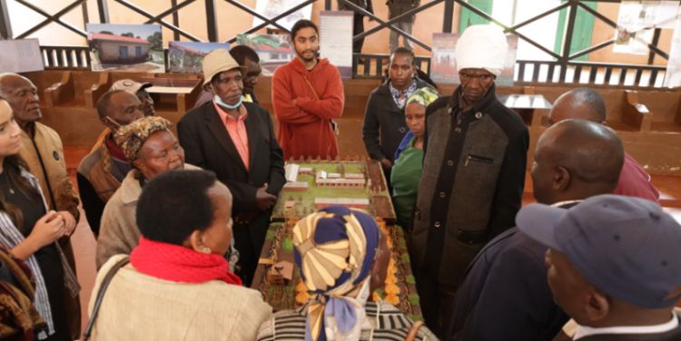 A group of people examining a museum  exhibit