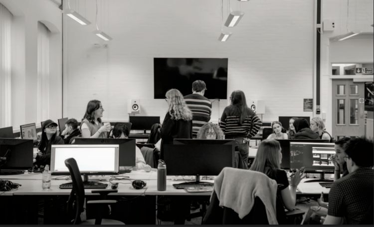 A black and white image of staff and students at the school of media and communication