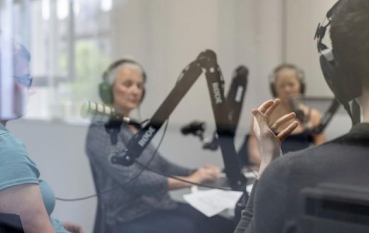 Four people creating a podcast in a studio