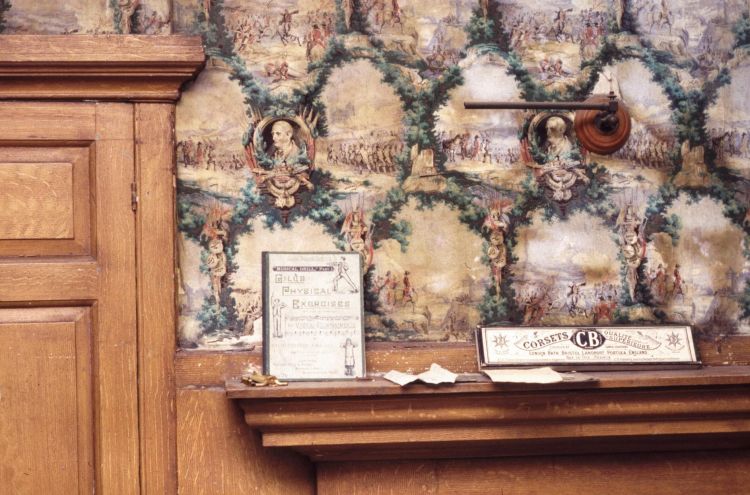 Wallpaper framed by wooden door and wood paneling, with images of the Duke of Wellington on the wall of the Waterloo Room at Burton Constable Hall.