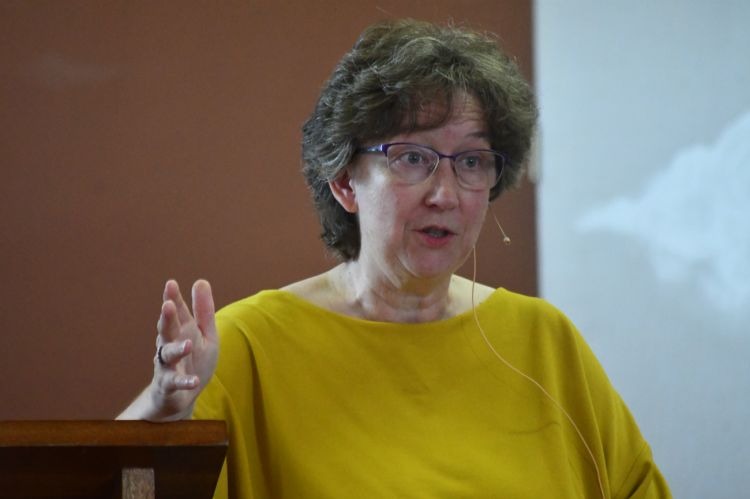 Helen Paynter standing at a lectern