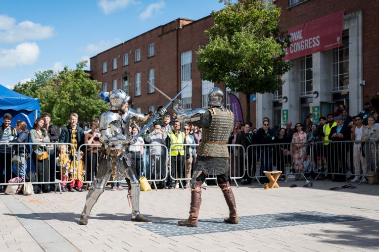 Re-enactors in armour demonstrating medieval combat techniques