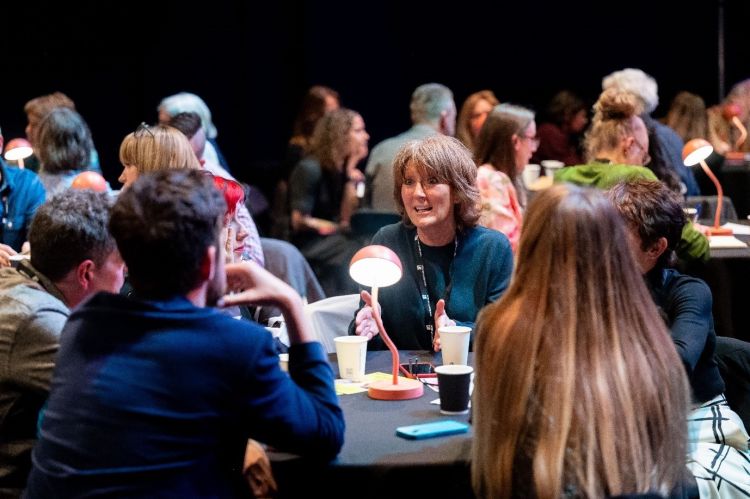 A group of people in discussion around a table