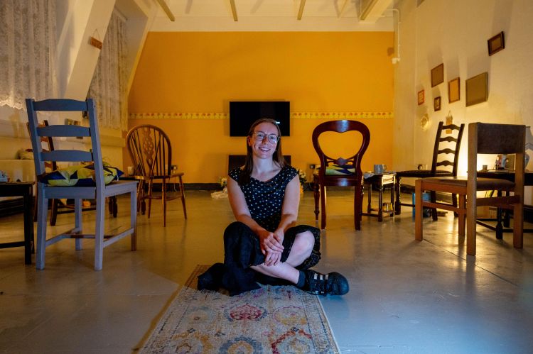 Annie Greenwood sitting with her audiovisual installation at the University of Leeds