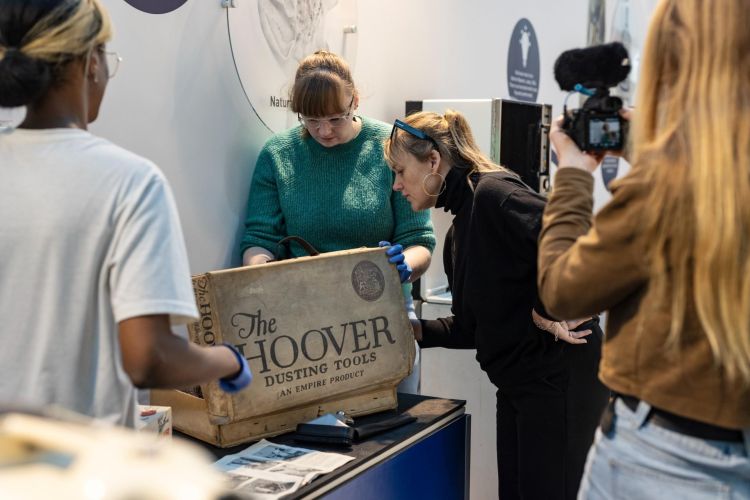 A group of people with museum objects