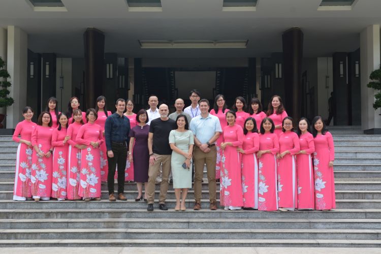 Staff and researchers stand on the steps outside the Independence Palace Museum in Ho Chi Minh City