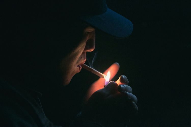 A photo of a cigarette being lit