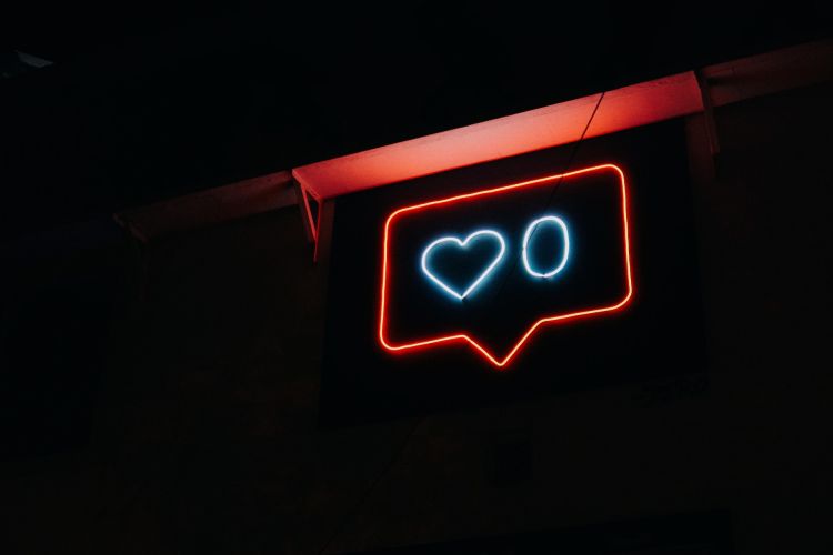 A neon sign that replicates the 'like' notification on Instagram.