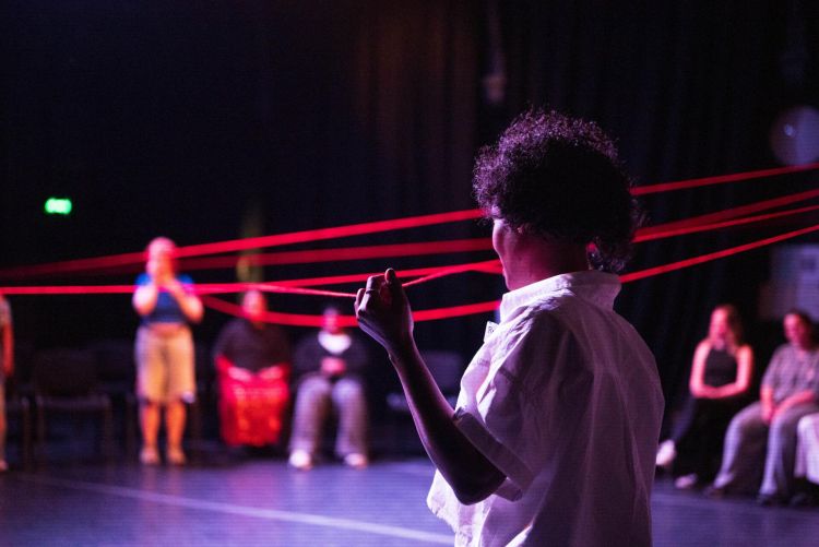 Performance in the round using red wool