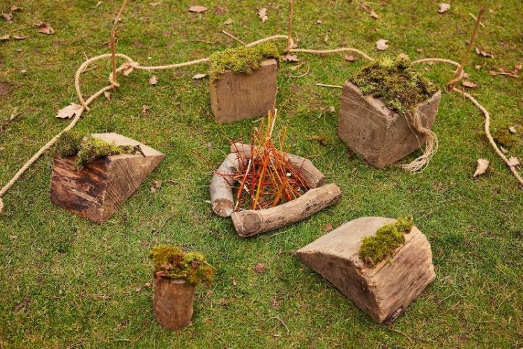 Sculptures made of natural materials such as wood placed on grass