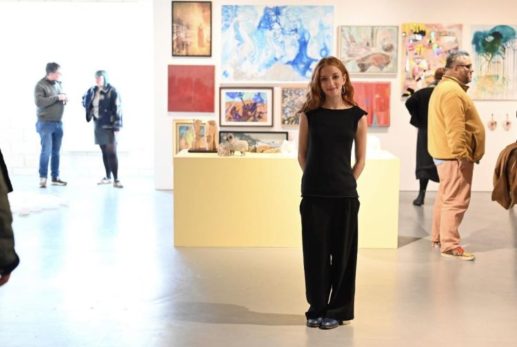 Artist Ella Brereton in an art gallery