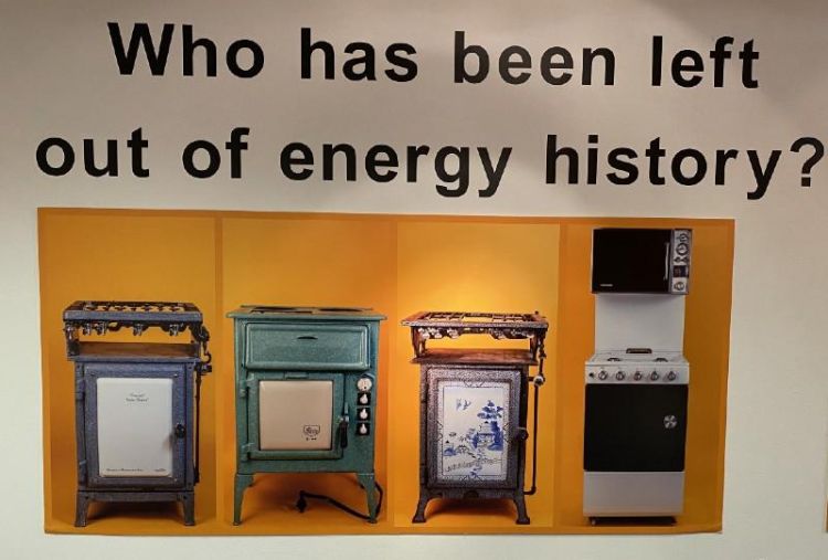 Exhibition panels showing four different cooking appliances with the words above them reading who has been left out of energy history?