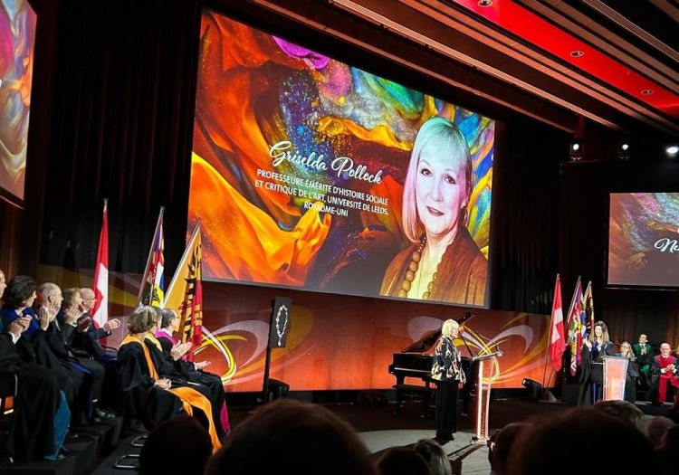 Award ceremony on a stage with screens in background