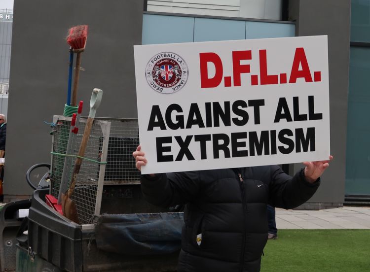 Person holds placard to protest against all extremism