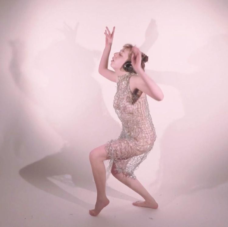 Artist Shadow Hart dancing in a paperclip dress