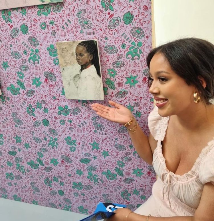 Artist Skye Davies with one of her paintings and wallpapers