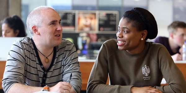 Two people chatting at a table