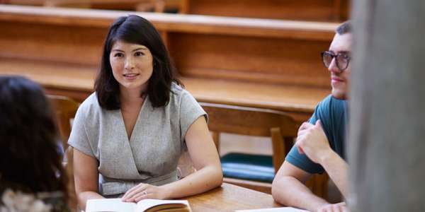 Students sat in a group at a library table