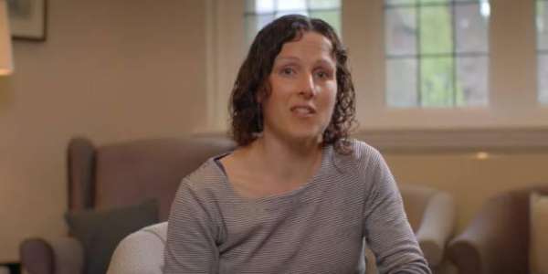 A screenshot from the video, Dr Mel Evans smiles to camera.