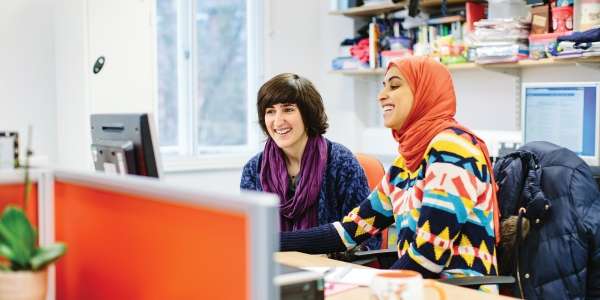 Student and mentor at a desk.