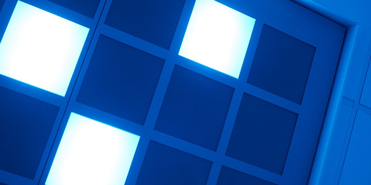 An art installation of a wall of a grid of blue and white squares