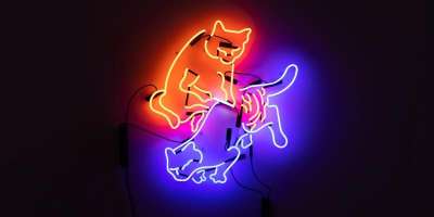 Red and blue Neon sculpture of a cat tatooing a cat with a black background
